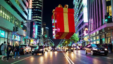 giant gift decorates city street at night