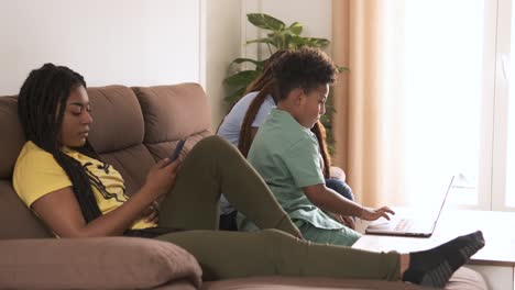 family members relaxing with devices in the living room