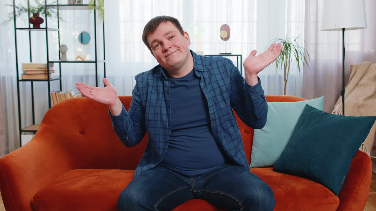 Confused young man feeling embarrassed about ambiguous question having doubts no idea being clueless