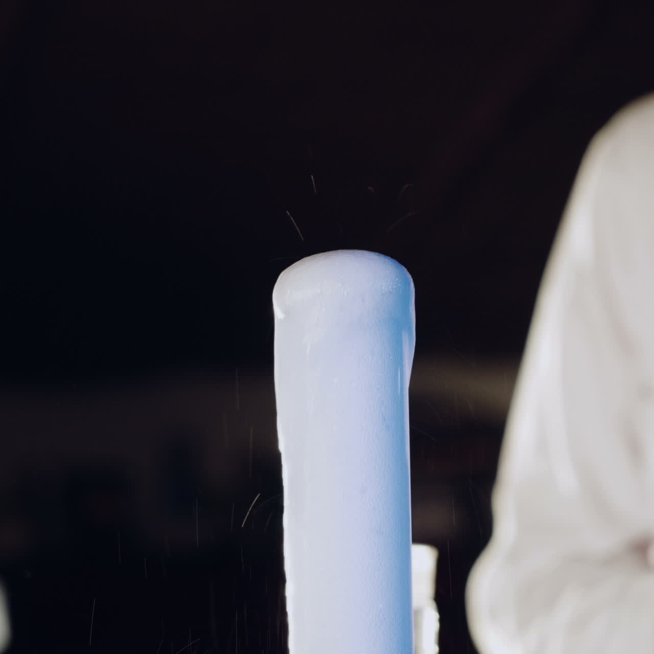 Woman scientist mixing together two liquid substances. Experiments in a chemistry lab. Close-up Square video