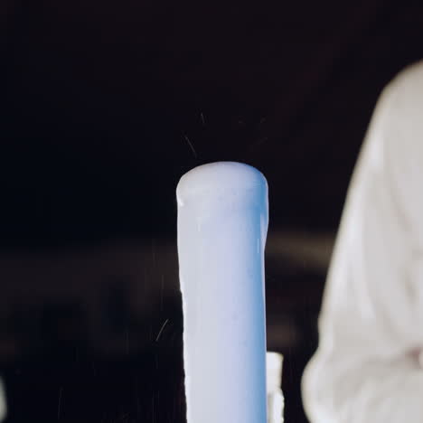 woman scientist mixing together two liquid substances. experiments in a chemistry lab. close-up square video