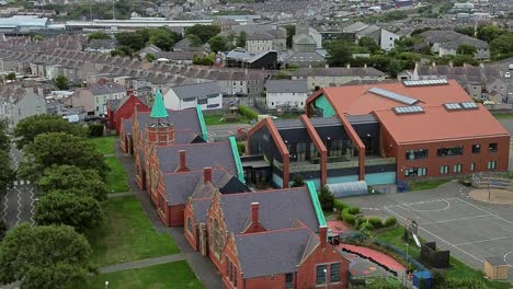 ysgol cybi welsh primary school aerial view red brick building with green copper spire in holyhead