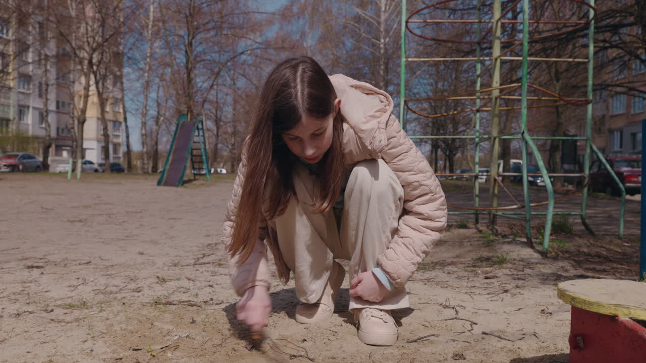 Girl playing in a playground sandpit