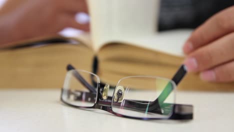 male student reading book withoot glasses