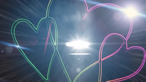 Digital-animation-of-bright-spot-of-light-against-neon-hearts-against-dark-background