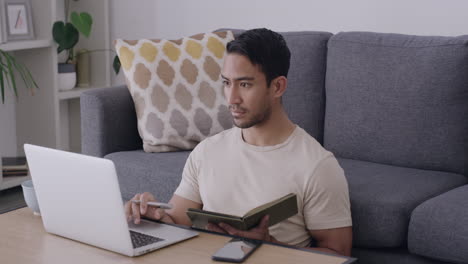 Male-student-researching-on-laptop