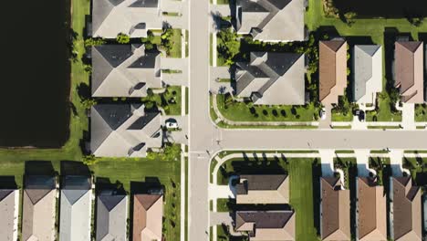 aerial of a sunny suburban neighborhood in tropical climate looking down at homes