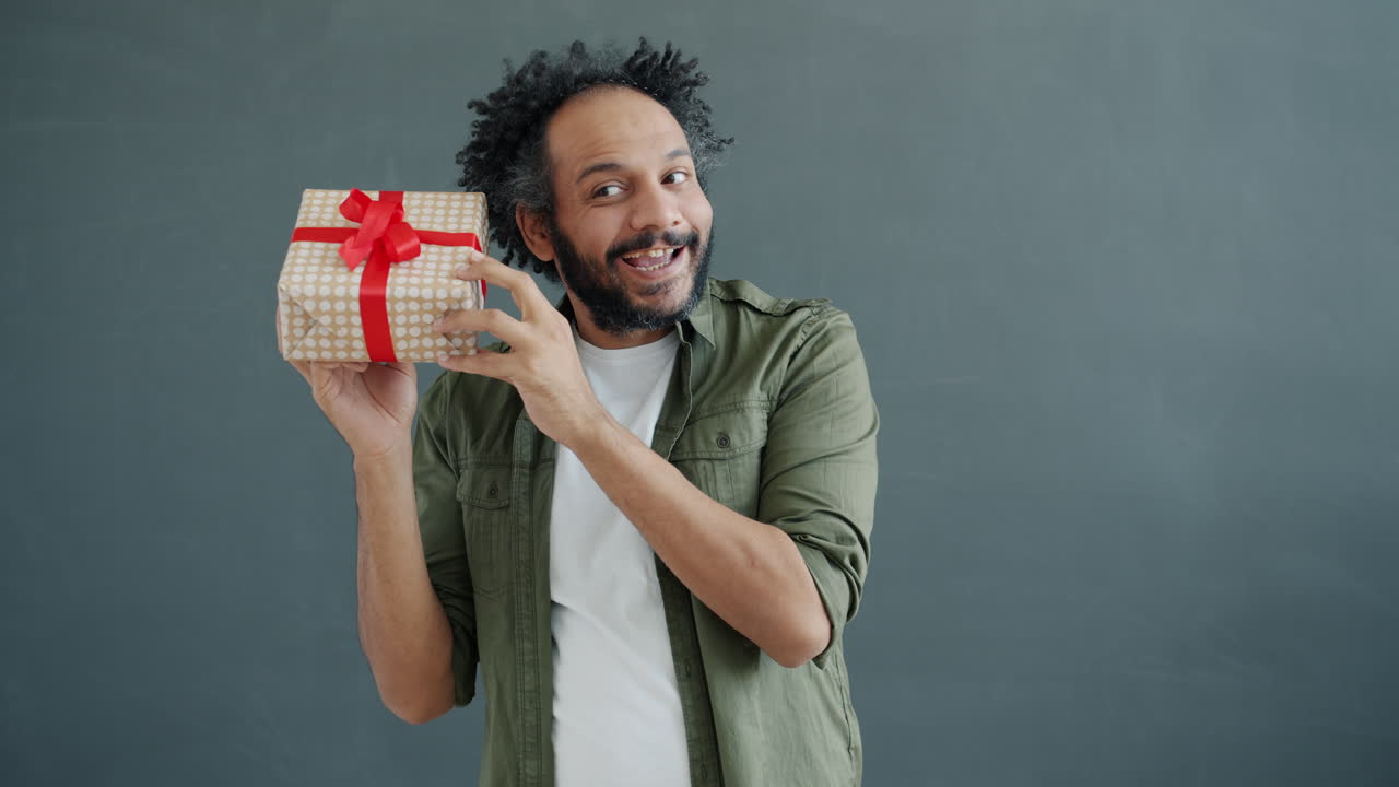 Man Excitedly Holding a Gift