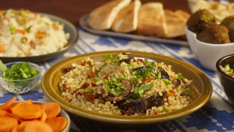 eating greenery on bulgur with eggplant close-up, couscous with meat on background. traditional middle eastern culture. delicious rice with meat. arabian cuisine. homemade food concept