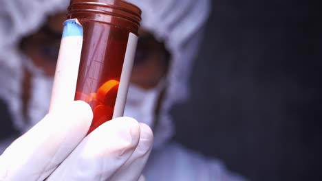 medical professional examining a pill container