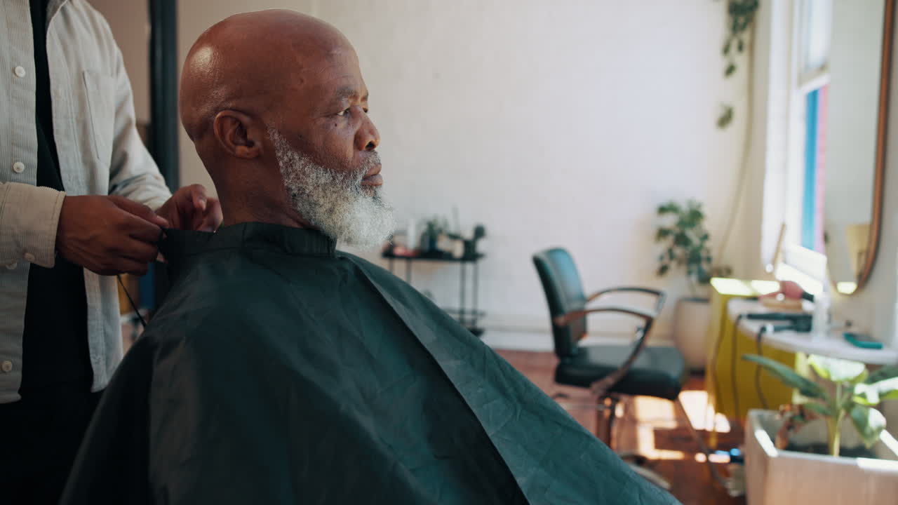 Barber Placing Cape on Senior Man in Barbershop