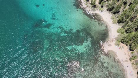 Drone-flying-over-rocky-lake-bed-in-east-lake-Tahoe