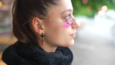 woman with glasses and earrings