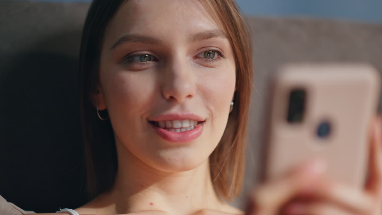 A young woman taking a selfie with her smartphone