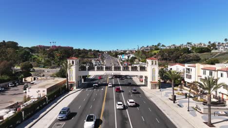 cars driving on pacific coast highway under the footbridge in dana point, california, usa