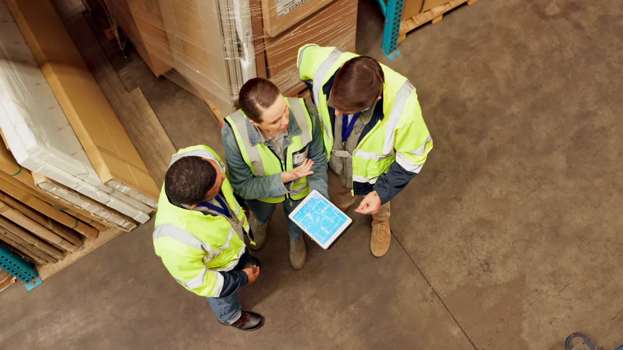 Warehouse workers collaborating on a tablet