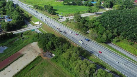 Busy-highway-road-and-tunnel-near-city,-aerial-drone-view