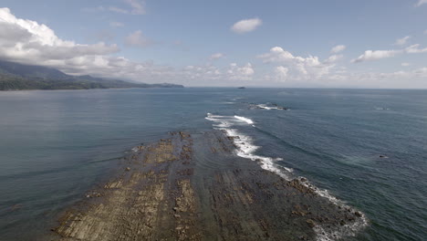 Flying-Low-Over-Rocks-Formed-Middle-Of-Sea-Water,-Trevallyn,Tasmania,-Australia