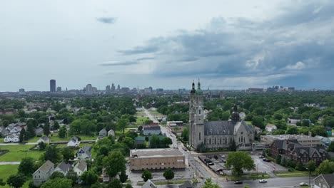 An-rising-aerial-view-of-the-green-city-of-Buffalo,-New-York-with-storm-clouds-in-the-distance