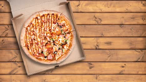 spinning motion animation of sliced pizza in cardboard box on the wooden table in restaurant. top view, copy space for text