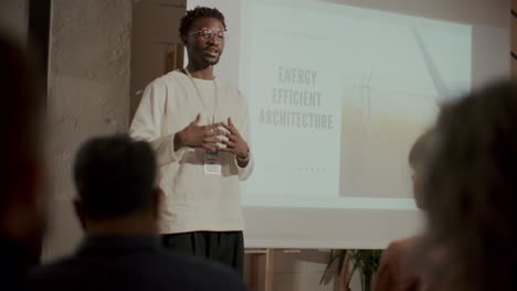 african american speaker presenting energy efficient architecture at seminar