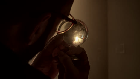 person examining a globe