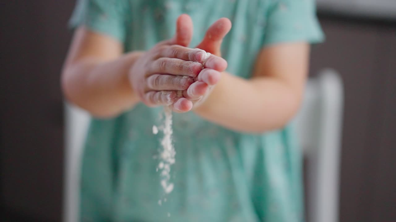 A Curious Child's Joyful Exploration with Flour: Capturing the Playful Moments of a Little One's Hands Covered in White Powdered Delight