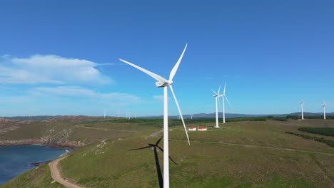 wind turbines on wind farm in the town of camarinas, spain - aerial drone shot