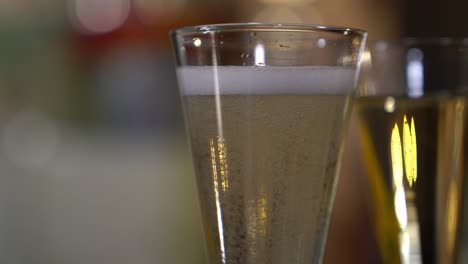 a shot of sparkling wine as the the bubbles rise to the top of the glass and settle down again