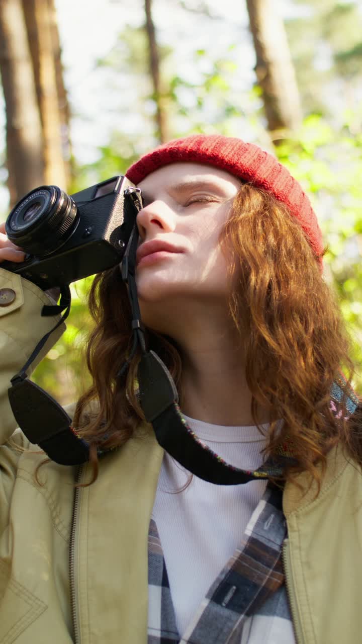 Woman taking a photo in the forest