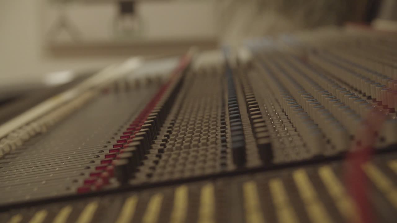 Recording studio - Vintage recording desk focus pull across the faders