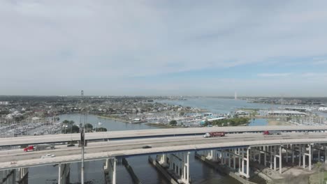 an aerial view of the kemah bridge with a new span, featuring clear lake and seabrook marina in the background, in kemah, texas