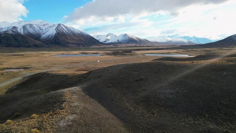 White-Van-Drives-Through-Mountainous-New-Zealand