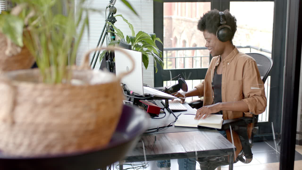 Uomo afroamericano felice in streaming audio dal vivo a casa, al rallentatore