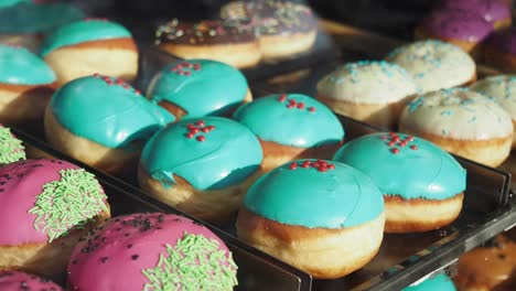 a display case full of colorful donuts