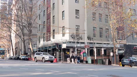 cars and pedestrians at a city intersection