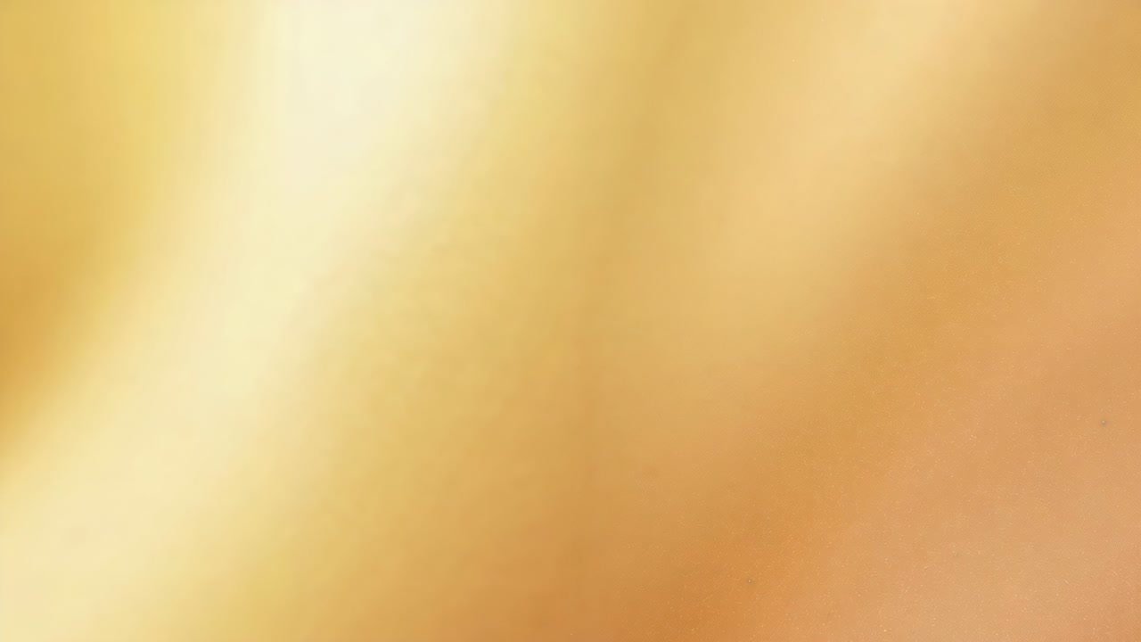 Covering fingertip moving across camera lens at handheld smartphone, creating warm blurred gradient