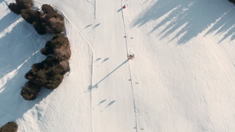 top down drone shot of empty ski slope and ski lifts