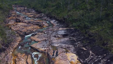 Aerial-over-the-creek-that-feeds-the-Big-Rock-Falls-in-the-Mountain-Pine-Ridge-Forest-Reserve,-Belize