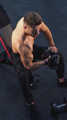 man doing dumbbell curls in gym