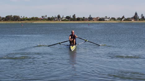 Senior-caucasian-man-rowing-boat-on-a-river