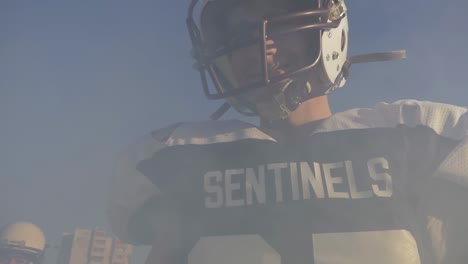 player in football uniform in smoke in slow motion