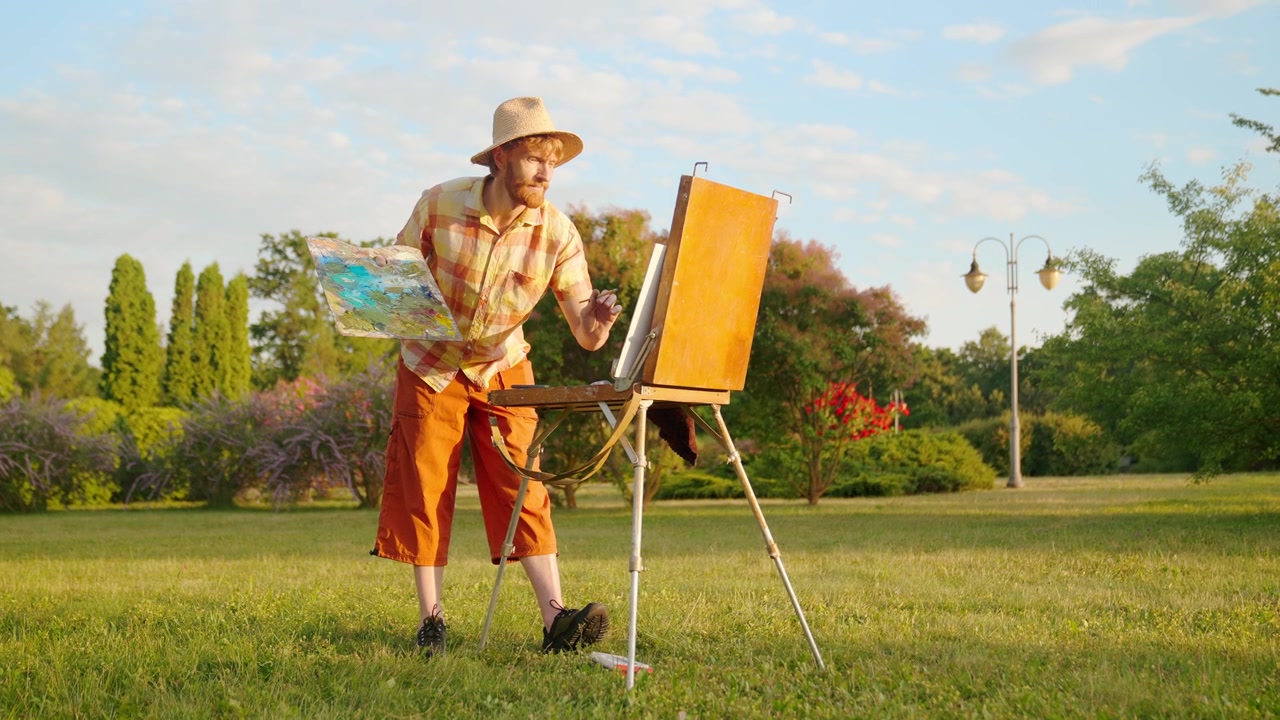 Man Painting on an Easel in a Sunny Park