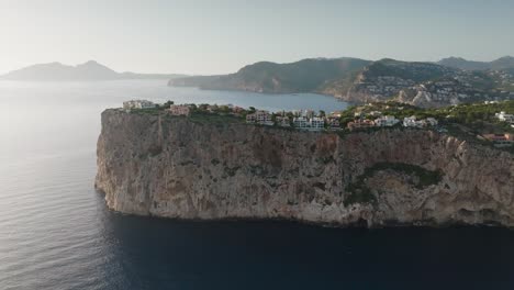 Aerial-view-of-steep-Mirador-de-la-Mola-seaside-cliff,-bright-day-in-Mallorca