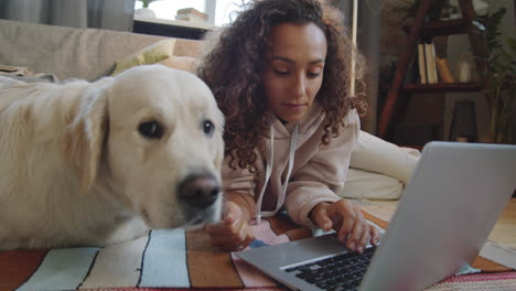 woman working on laptop with dog