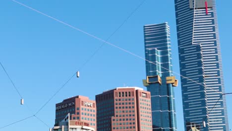 tall buildings and hanging lights set against a bright blue sky, showcasing urban architecture and design.