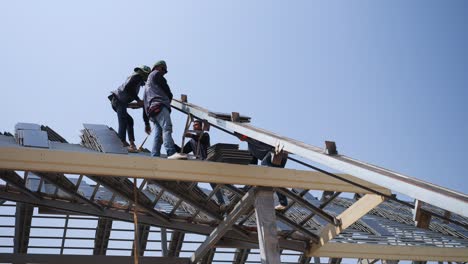 architectural construction industry team professional roofing workers using machinery transporting concrete tiles stacking beautifully before install