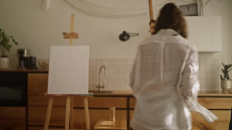 mother and daughter painting together in a kitchen