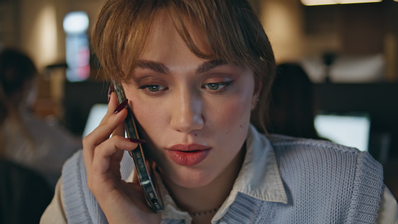 Young lady calling cellphone at late office closeup. Woman consulting client