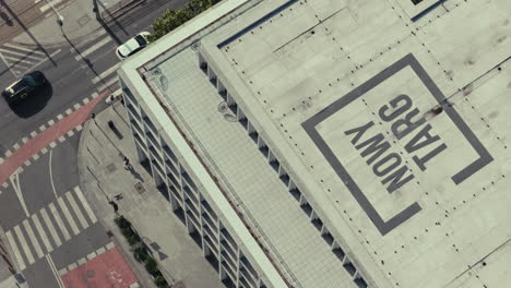 aerial view of a city intersection and building with parking garage
